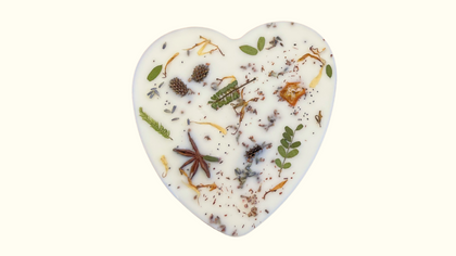 Top view of Mary Heartful Wax Melt by MeaQuasar, heart-shaped eco-friendly wax melt with botanical elements like pine, cedar, and patchouli on a white background. Sustainable home fragrance product with natural, woodsy scent.